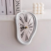 Melting clock sculpture draped over a shelf edge