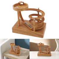 Kinetic perpetual motion machine with a steel ball rolling through looping metal tracks