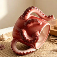 Ceramic mug wrapped in a sculpted octopus tentacle